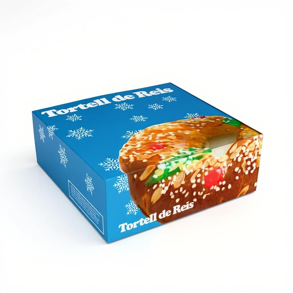 Caja de cartón azul con copos de nieve y diseño navideño para Tortell de Reis, con fotografía del roscón en la tapa y ventana frontal, sobre fondo blanco